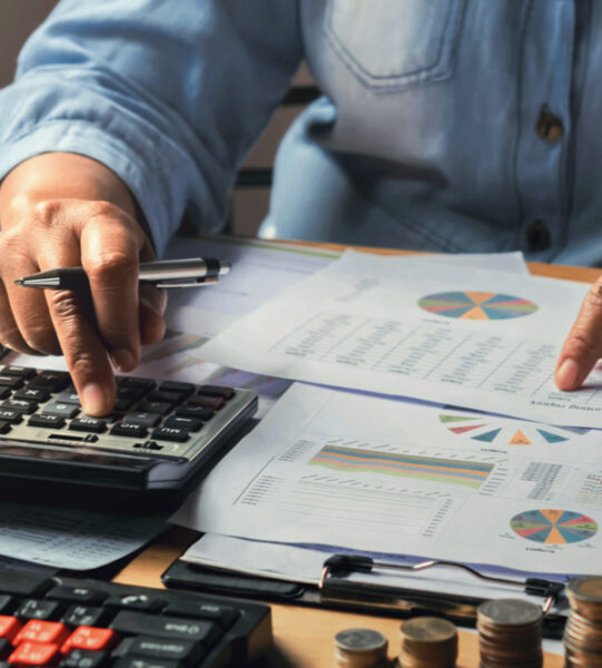 accounting-concept-businesswoman-working-using-calculator-with-money-stack-office